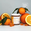 Sugar Island CBD RISE cbd/hemp cbd oil/hemp oil infused gummies; closed jar surrounded by orange gummies and fresh clementines and oranges on white backdrop