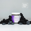 Sugar Island CBD REST cbd/hemp cbd oil/hemp oil infused gummies; closed jar surrounded by dark purple gummies and blackberries on white backdrop