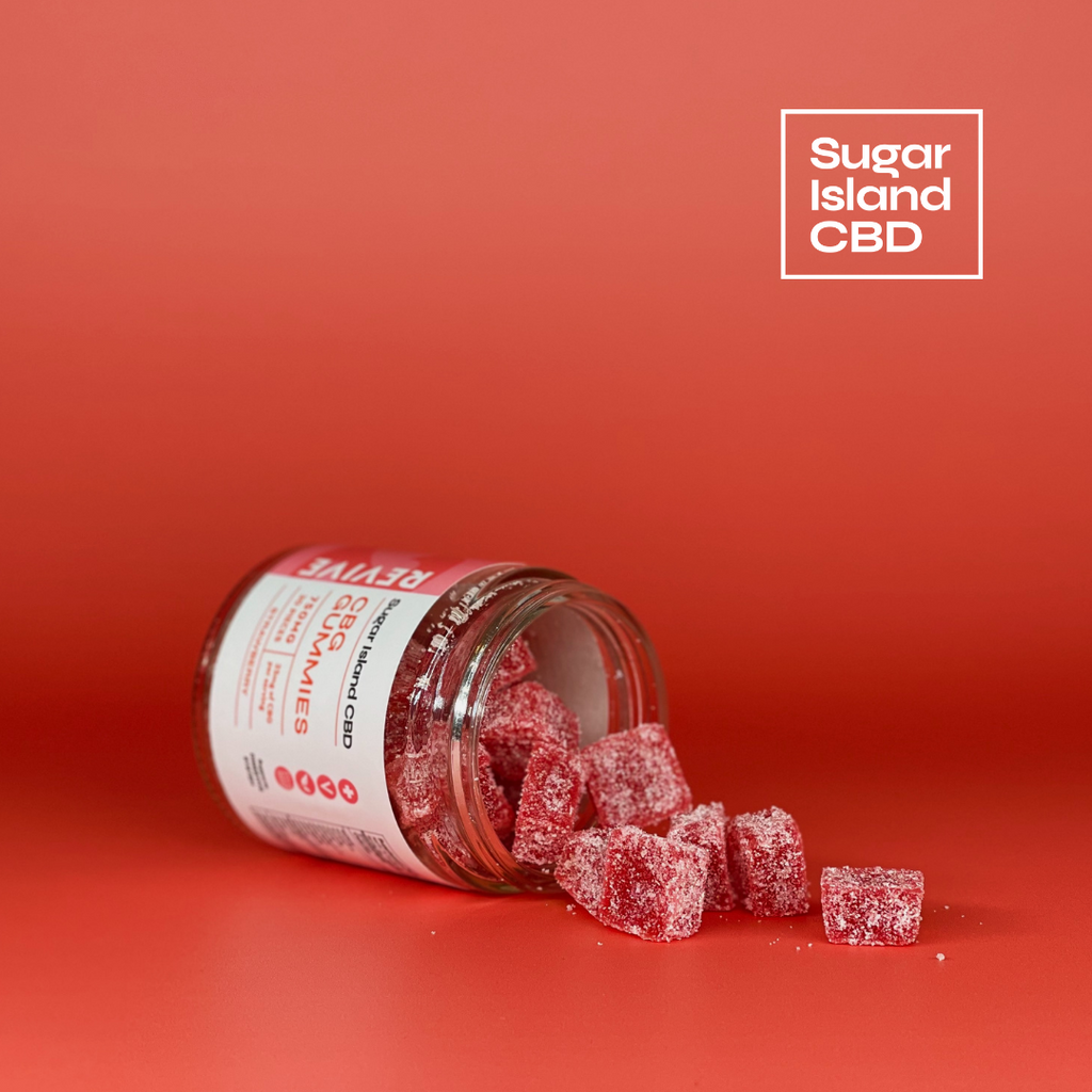 Sugar Island CBD REVIVE cbd/hemp cbd oil/hemp oil infused gummies; red gummies spilling out of tipped over jar on red backdropl